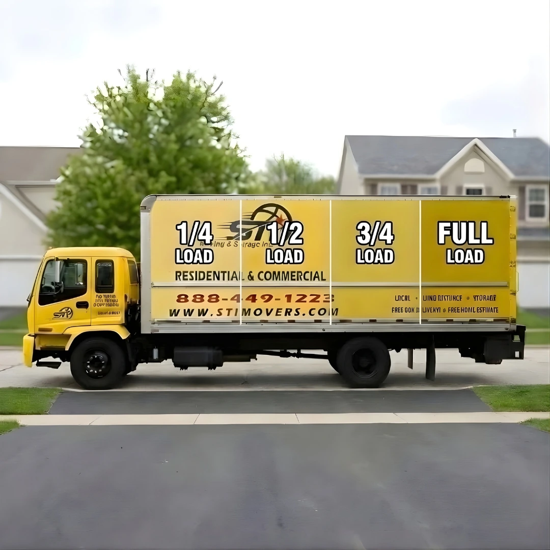 STI Movers truck displaying volume-based junk removal pricing structure with quarter, half, three-quarter, and full load options
